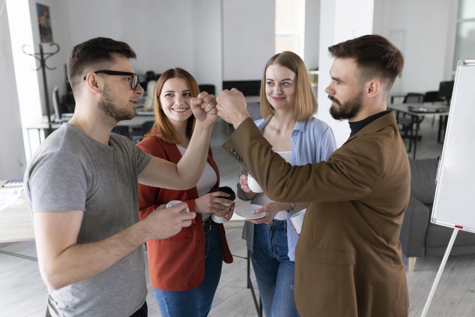 group-of-coworkers-at-the-office-talking-scaled.jpg